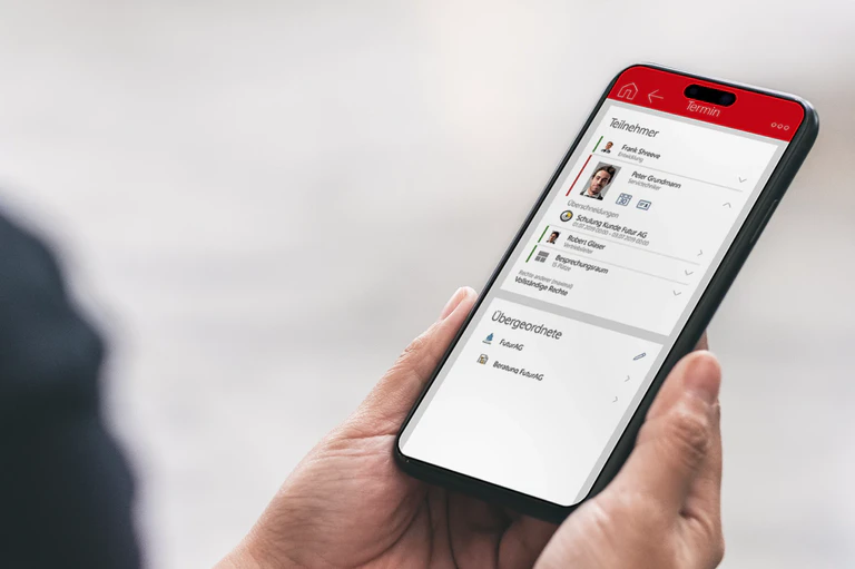 Person verwaltet Termine an mobilem Endgerät