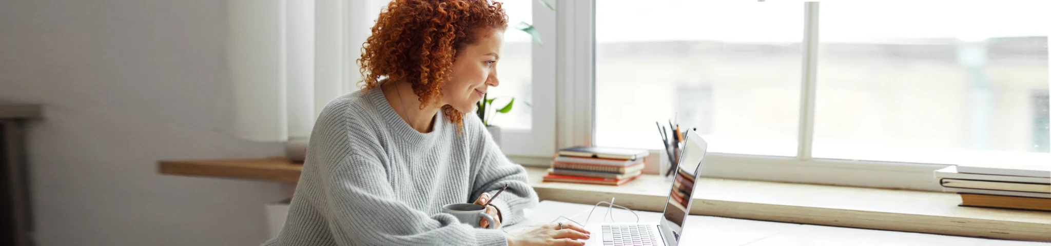 Frau schaut ein Tutorials über CRM, CPQ und AIA am Laptop
